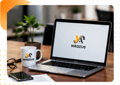 WAGZUS branded laptop and coffee mug on a wooden office desk with a smartphone, eyeglasses, and a potted plant